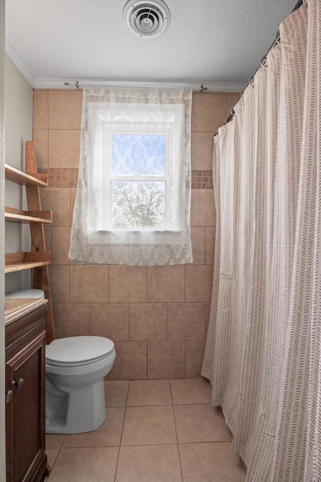 full bath featuring visible vents, toilet, tile patterned flooring, a textured ceiling, and vanity