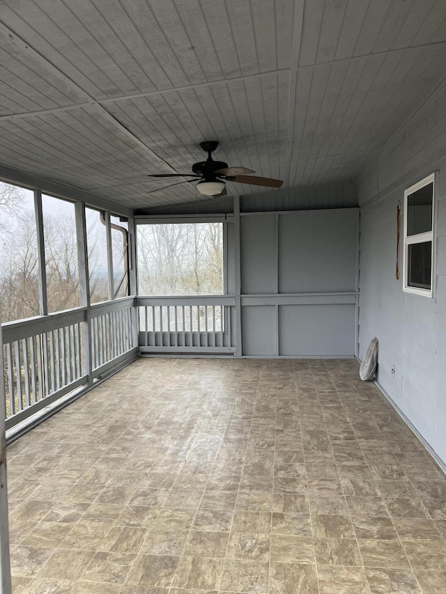 unfurnished sunroom with a ceiling fan