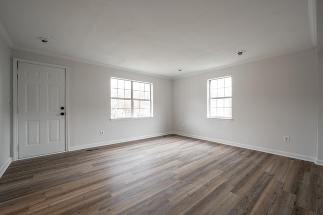 empty room with crown molding and dark hardwood / wood-style floors