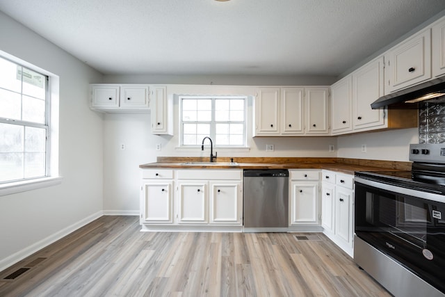 kitchen with sink, stainless steel appliances, and white cabinets