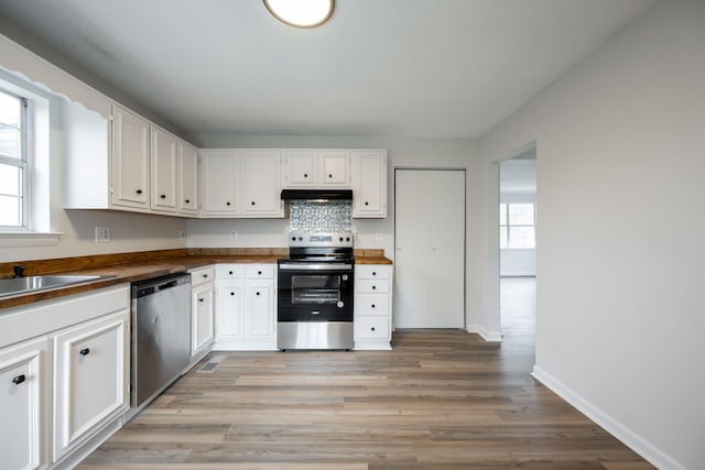 kitchen featuring light wood-type flooring, white cabinets, and appliances with stainless steel finishes