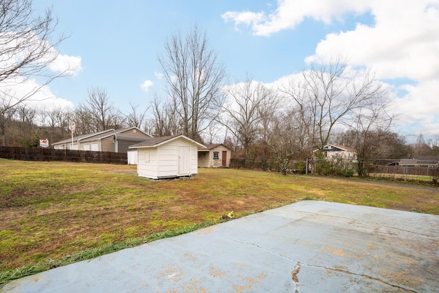 view of yard with a patio and a storage shed