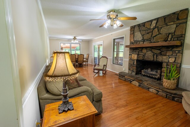 446 Jamestown Rd, Menlo, GA 30731 - living room featuring crown molding, wood-type flooring, ceiling fan, and a fireplace