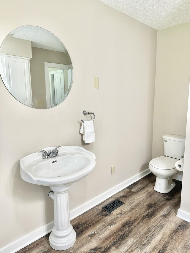 446 Jamestown Rd, Menlo, GA 30731 - bathroom with hardwood / wood-style flooring, a textured ceiling, and toilet