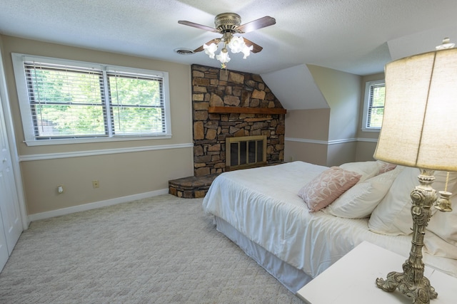 446 Jamestown Rd, Menlo, GA 30731 - bedroom with ceiling fan, a stone fireplace, a textured ceiling, and carpet flooring
