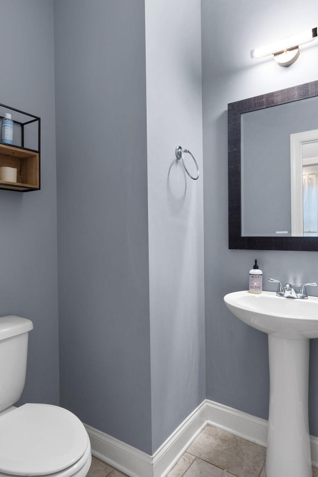 bathroom featuring toilet and tile patterned flooring