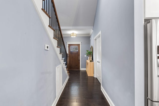 corridor featuring dark wood-style floors, stairs, visible vents, and baseboards