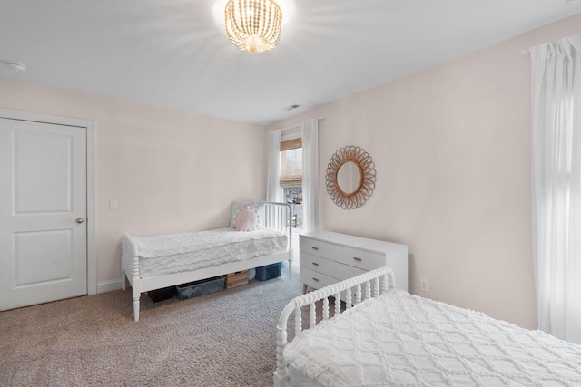 carpeted bedroom featuring visible vents