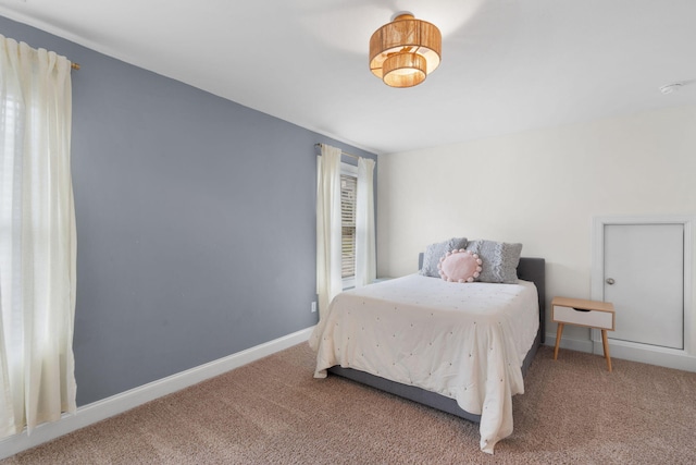 bedroom with carpet flooring and baseboards