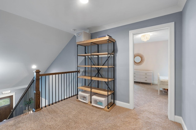 hallway featuring vaulted ceiling and light carpet