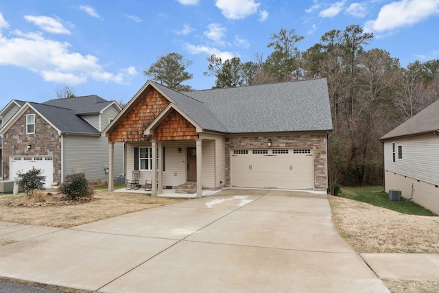 view of front of house featuring a garage and central AC unit