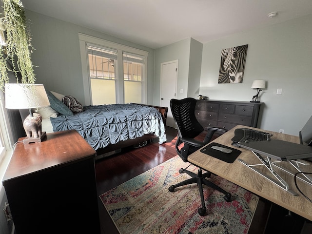 bedroom with dark wood-type flooring