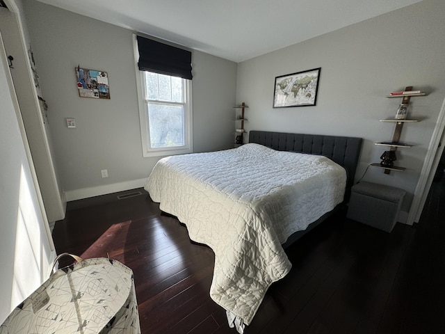 bedroom with dark wood-type flooring