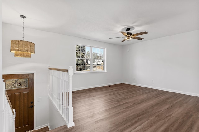 spare room featuring ceiling fan and dark hardwood / wood-style flooring