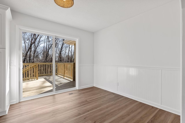 empty room featuring hardwood / wood-style floors and a textured ceiling