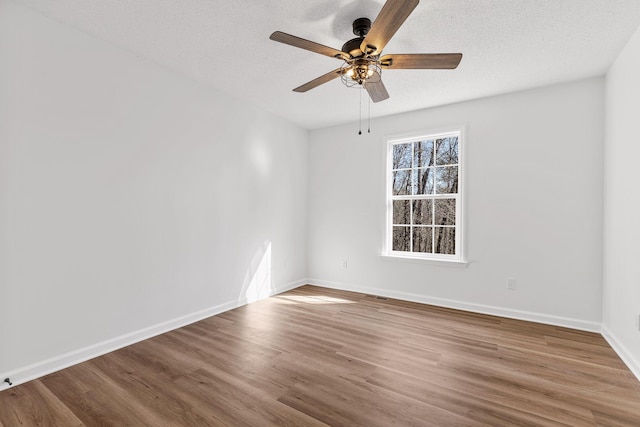 unfurnished room with wood-type flooring, ceiling fan, and a textured ceiling