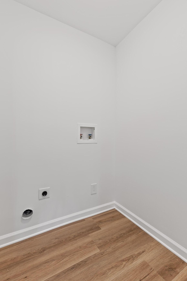 clothes washing area with hookup for a washing machine, wood-type flooring, and hookup for an electric dryer