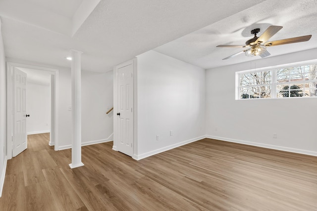 interior space with ceiling fan, a textured ceiling, and light hardwood / wood-style floors