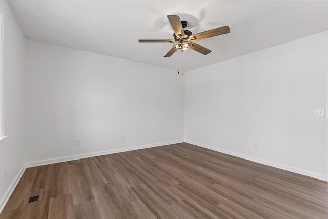 spare room featuring hardwood / wood-style floors and ceiling fan