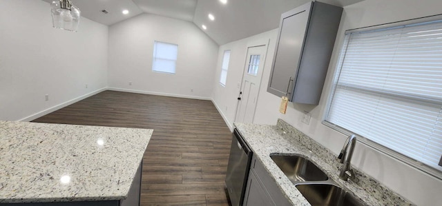 kitchen featuring light stone counters, lofted ceiling, gray cabinets, and dishwasher