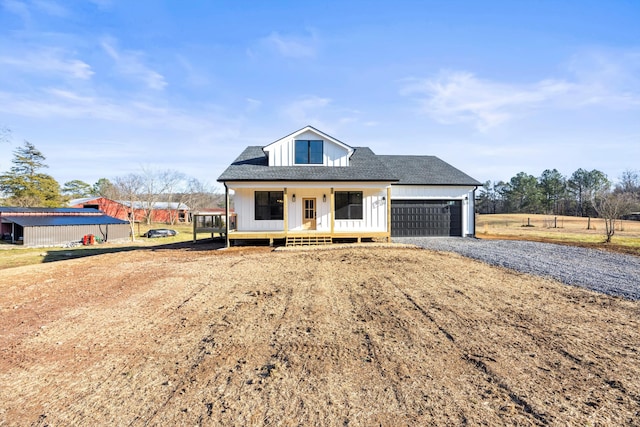 view of front of property featuring a porch and a garage