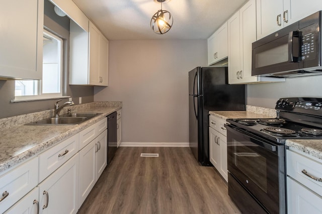 kitchen featuring sink, dark wood-type flooring, black appliances, and white cabinets