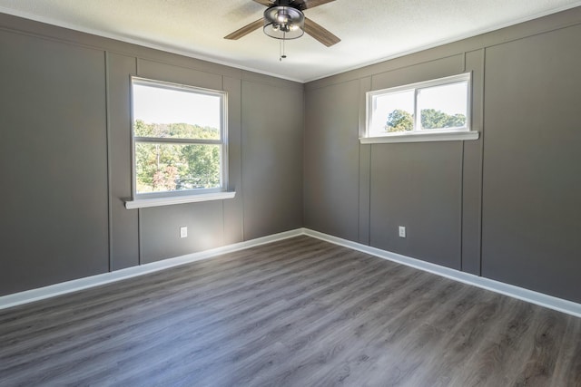 spare room featuring ceiling fan, plenty of natural light, and wood-type flooring