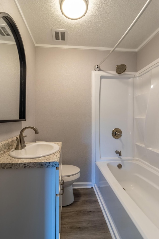 full bathroom featuring shower / tub combination, hardwood / wood-style flooring, vanity, toilet, and a textured ceiling