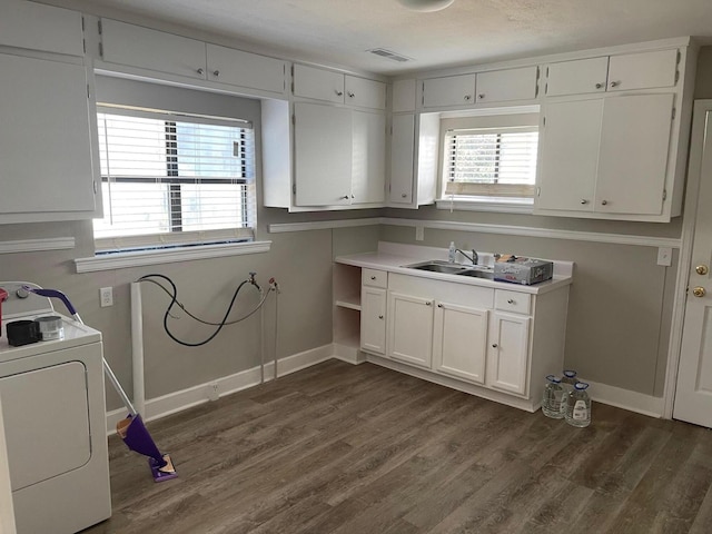 washroom featuring washer / clothes dryer, dark wood-type flooring, cabinets, and sink