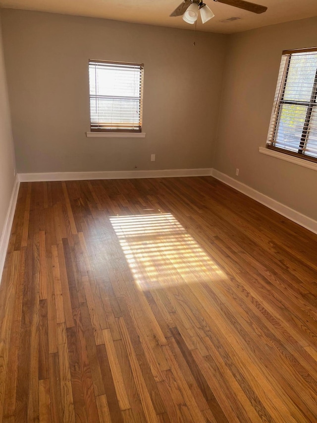 spare room featuring dark hardwood / wood-style flooring and ceiling fan