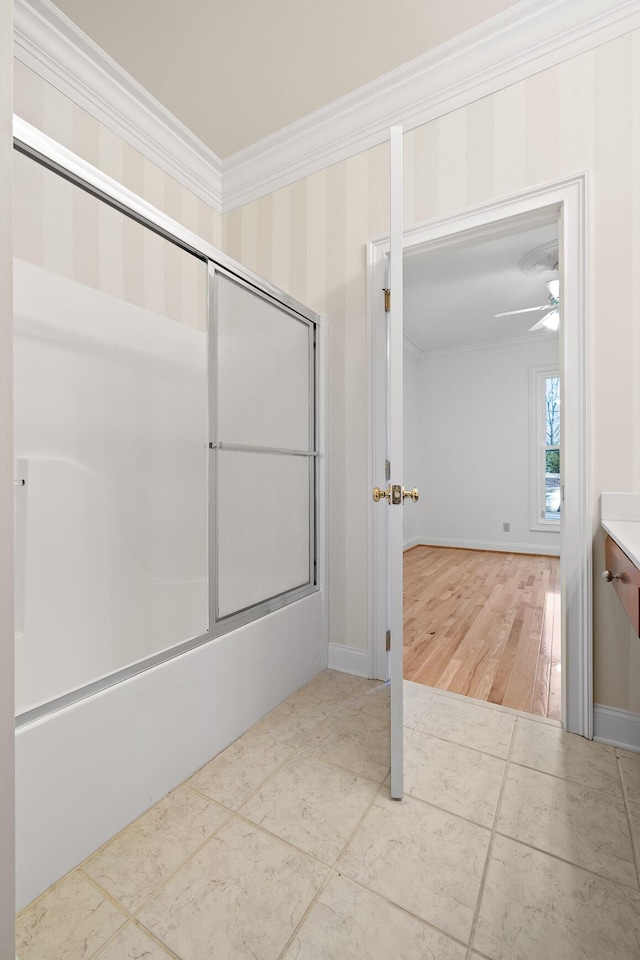 bathroom featuring bath / shower combo with glass door, ornamental molding, and baseboards