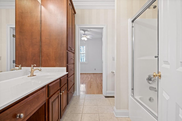 full bathroom with wallpapered walls, tile patterned flooring, combined bath / shower with glass door, crown molding, and vanity