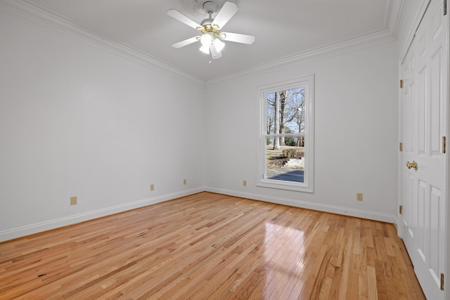 empty room featuring baseboards, crown molding, light wood finished floors, and ceiling fan