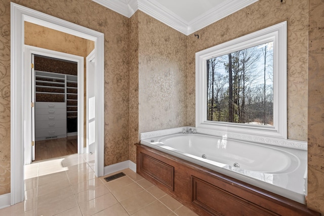 bathroom with wallpapered walls, baseboards, a tub with jets, ornamental molding, and tile patterned floors