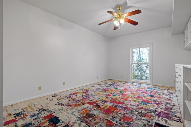 interior space featuring ceiling fan and baseboards