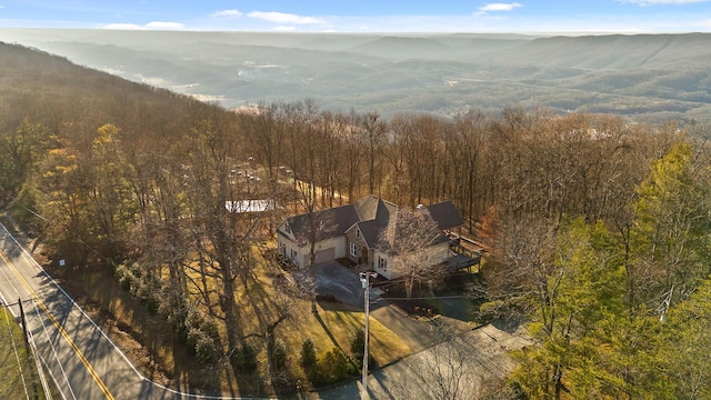 drone / aerial view with a mountain view and a view of trees