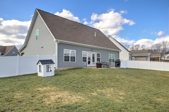 back of property featuring french doors, a patio area, and a lawn