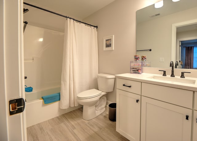 full bathroom featuring vanity, shower / bath combination with curtain, and toilet