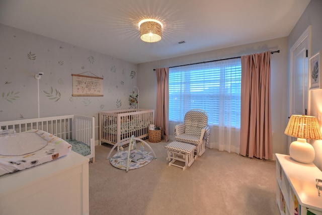 carpeted bedroom featuring a crib