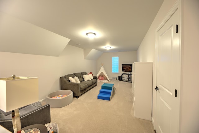 interior space with vaulted ceiling and light colored carpet