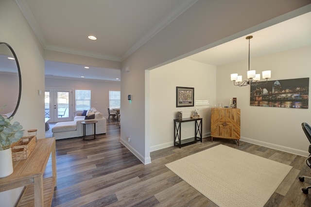 interior space with ornamental molding, a chandelier, and dark hardwood / wood-style flooring