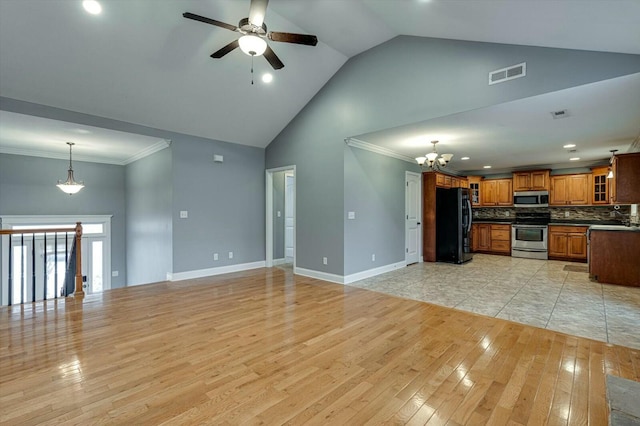 unfurnished living room featuring ceiling fan with notable chandelier, high vaulted ceiling, sink, crown molding, and light hardwood / wood-style flooring