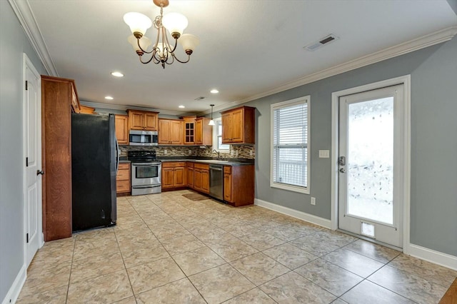 kitchen featuring crown molding, hanging light fixtures, backsplash, and stainless steel appliances