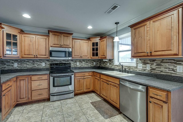 kitchen with stainless steel appliances, crown molding, sink, and decorative light fixtures