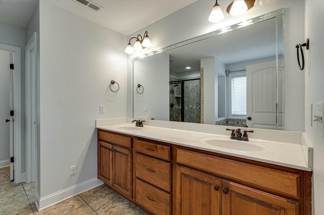 bathroom with tile patterned floors, vanity, and a shower with shower door