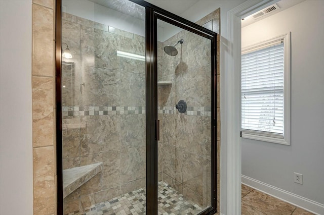 bathroom with walk in shower and tile patterned floors