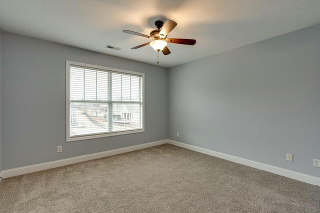 carpeted empty room featuring ceiling fan