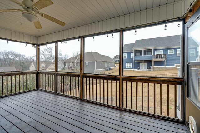 unfurnished sunroom featuring plenty of natural light and ceiling fan