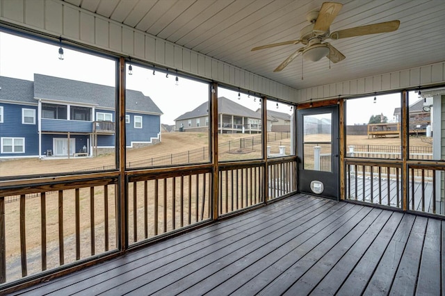 unfurnished sunroom featuring plenty of natural light and ceiling fan