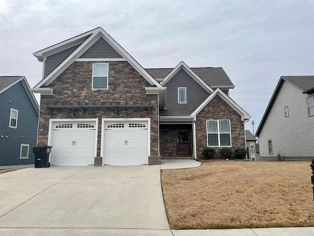 craftsman-style home featuring a garage and a front lawn